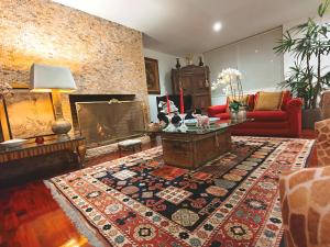 a living room with a couch and a fireplace at Ana Frank Boutique Hotel in Lima