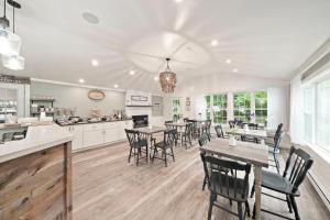 a kitchen and dining room with tables and chairs at Sandwich Inn and Suites in Sandwich