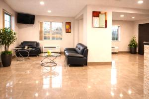 a living room with black leather furniture and a table at Microtel Inn by Wyndham - Murfreesboro in Murfreesboro