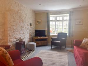 a living room with a couch and a fireplace at The Anchorage in Staithes