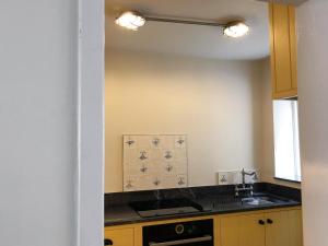 a kitchen with a sink and a stove at The Anchorage in Staithes +26 photos