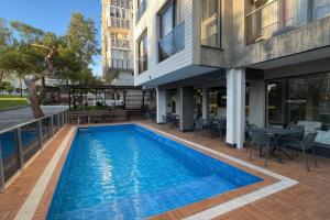 a swimming pool in front of a building at Ramona Lara in Antalya