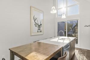 a kitchen with a wooden counter top and a sink at Cloudline Vista 3 BdrmTownhouse w Private Garage Views Pool Walk Downtown in Canmore