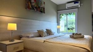 a bedroom with a large bed with a window at LS Hotel in Salta
