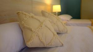 two white pillows on top of a bed at LS Hotel in Salta