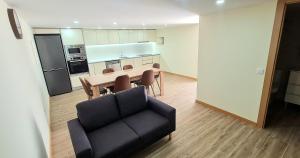 a living room with a table and a couch at Quinta da Toqueira in Canedo