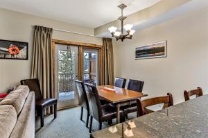 a living room with a table and a couch at Spacious, Pet Friendly, Townhouse Hot Tub Perfect for Families! in Canmore