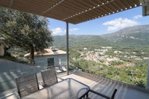 a view from the balcony of a house with a table and chairs at Saint Helen Villas in Parga