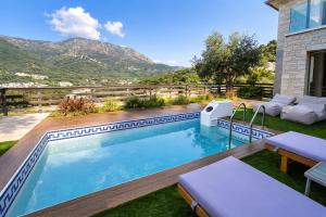 a swimming pool with a view of the mountains at Saint Helen Villas in Parga +13 photos