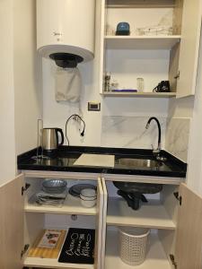 a kitchen with a sink and a stove at Apartamentos TerraLoft in San Antonio