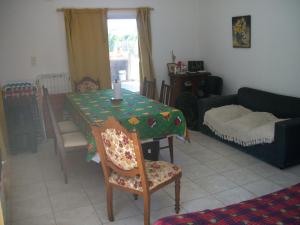 a living room with a table and a couch at Capibara Matero in Roldán