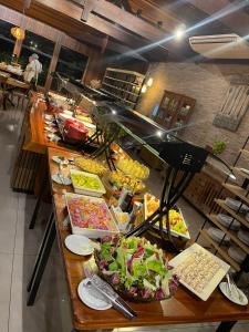 a buffet line with many different types of food at Chalé dos Lagos Ecoresort in Mandaguaçu