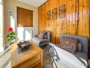 a living room with two chairs and a table at Casa Rosa in Prestatyn