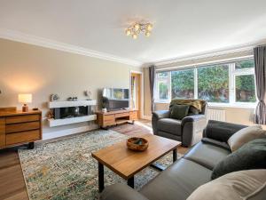 a living room with a couch and a tv at Casa Rosa in Prestatyn