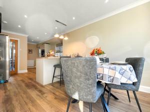 a kitchen and dining room with a table and chairs at Casa Rosa in Prestatyn