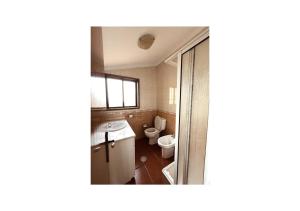 a bathroom with a toilet and a sink at Casa Quixote Matosinhos in São Mamede de Infesta +7 photos