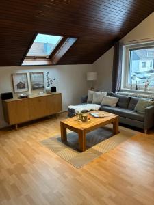 a living room with a couch and a table at Harz-Urlaub-Altenau - Hunde willkommen in Altenau