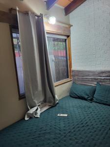 a bedroom with a bed with a sheet on it at Complejos Residenciales Las Lomitas in San Lorenzo de la Frontera