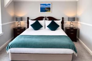 a bedroom with a large bed with two night stands at Aran View Holiday Homes Doolin - The Atlantic Stone House - Ocean Views in Doolin