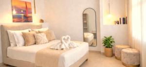 a bedroom with a white bed with a mirror at Knossos Sunrise in Palekastron