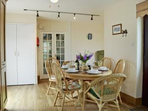 a dining room with a table and chairs at Ty Cornel in Aberporth