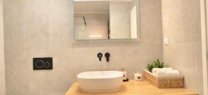 a bathroom with a white sink and a mirror at Knossos Sunrise in Palekastron
