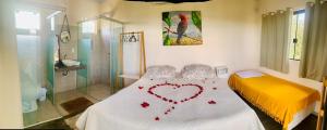 a bedroom with a bed with a heart on it at Chales Estrela Veadeiros Com Ofurô in Alto Paraíso de Goiás