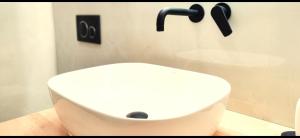 a white sink in a bathroom with a shower at Knossos Sunrise in Palekastron