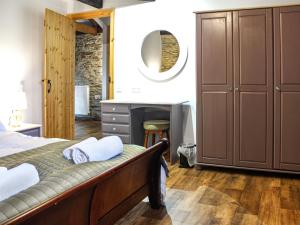 a bedroom with a bed with a vanity and a mirror at The Hayloft - Uk50027 in Liskeard +5 photos