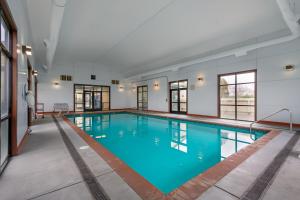 a large pool with blue water in a building at Rogue Regency Inn Medford Airport in Medford