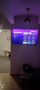 a projection screen on a wall in a room at Bungalow Josefina flores in Lo de Marcos +8 photos