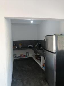 a kitchen with a stainless steel refrigerator in a room at Bungalow Josefina flores in Lo de Marcos