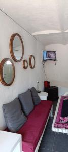 a room with a bed with two pillows and mirrors at Bungalow Josefina flores in Lo de Marcos