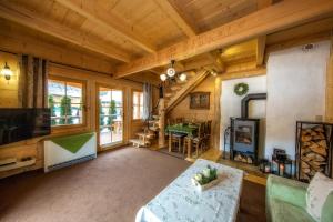 a living room with a table and a fireplace at Domek Otulina in Zakopane