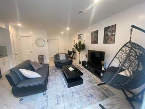 a living room with a couch and a swing at Ekimo Elite Leisure in Jersey City