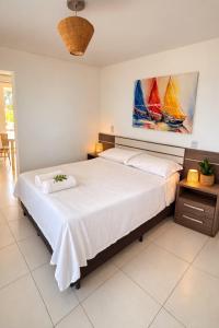 a bedroom with two beds and a painting on the wall at Residence Cumbuco Paradise Beach in Cumbuco +87 photos