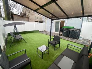 a patio with a table and chairs and a ping pong table at Ekimo Elite Leisure in Jersey City