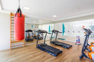 a gym with several treadmills and a punching bag at Apto Porto de Galinhas in Porto De Galinhas