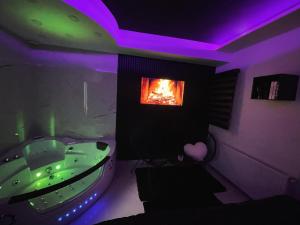 a bathroom with a tub and a fire in a window at Tina apartman in Vranje +16 photos