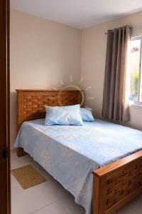 a bedroom with a bed with blue sheets and a window at Apto Porto de Galinhas in Porto De Galinhas +88 photos