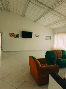 a living room with two couches and a flat screen tv at Alborada Chinauta in La Serena