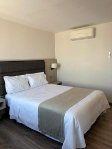 a bedroom with a large bed with white sheets at Hotel Nube, Puebla Centro in Puebla +33 photos