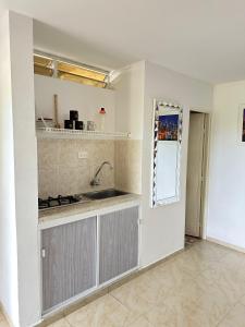 a kitchen with a sink and a counter top at San Alejo in Tuluá