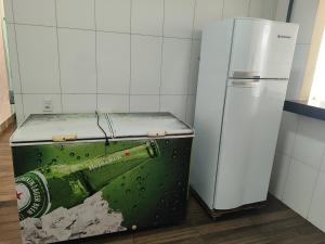 an old bottle of beer sitting on top of a refrigerator at Aluguel de um quarto - Espaço Maranata in Porangatu