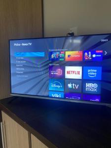 a flat screen tv sitting on top of a table at Quarto suíte privativa in Xaxim