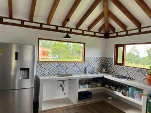 a kitchen with a sink and a refrigerator at Casa Silvestre in Villa de Leyva +65 photos