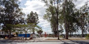 a skate park with a skateboard ramp and trees at Suite confort 02 in Contagem