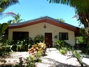 a house on the beach with palm trees at Primer Canto B&B - Near Ferry & Early Birdwatching Trails in Lepanto