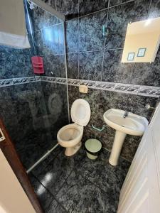 a bathroom with a toilet and a sink at Hotel Morada de Leste Pontal in Pontal do Paraná +48 photos