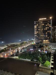 a tall building with lights on top of it at night at Tuyết Nhi in Vung Tau